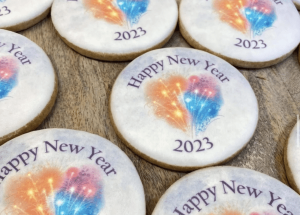 A close up of cookies with happy new year 2 0 2 3 written on them